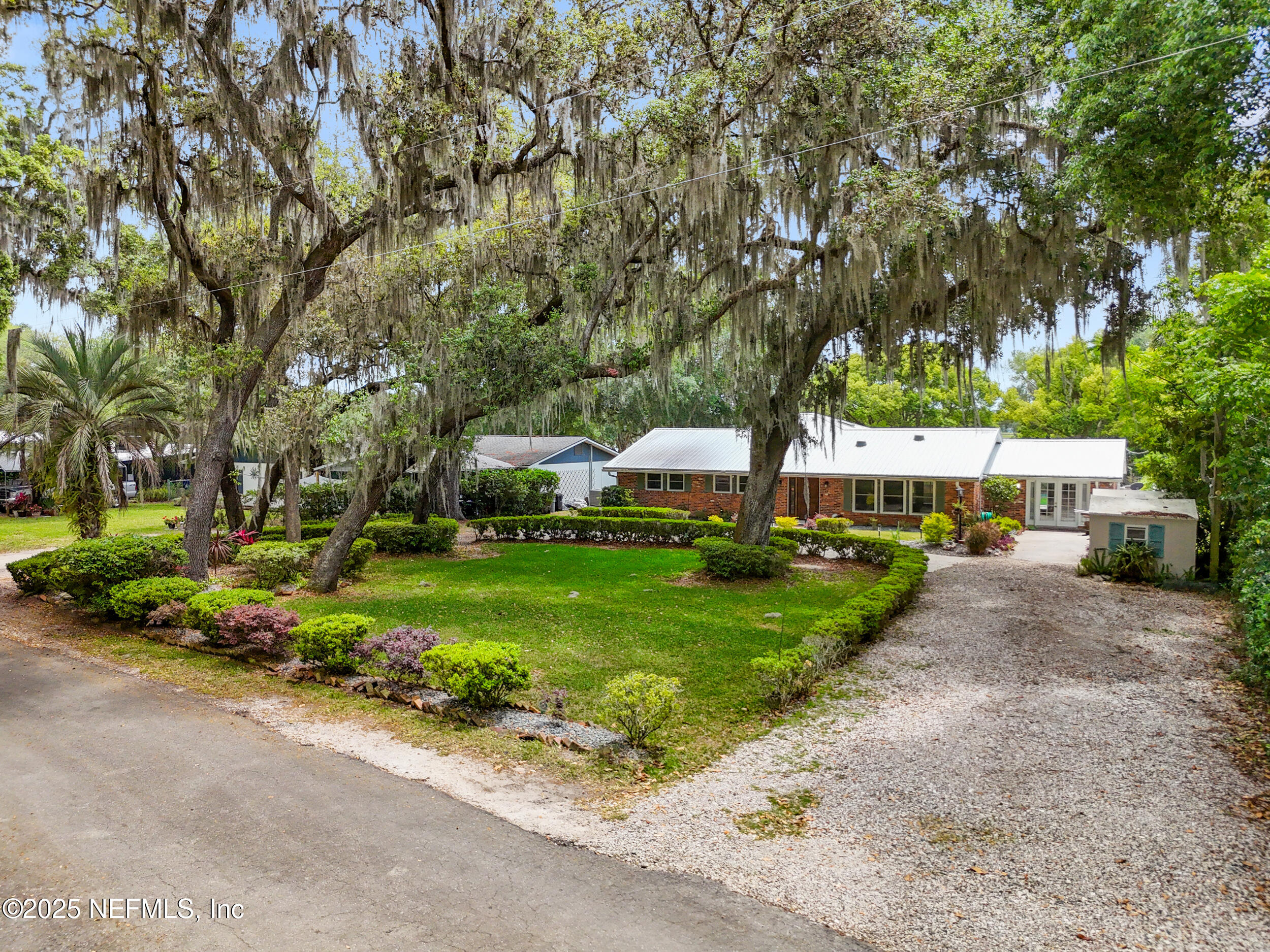 49 Nelsons Point Keystone Heights, FL 32656 - Photo 2 of 34 a view of a park with large trees and cars parked