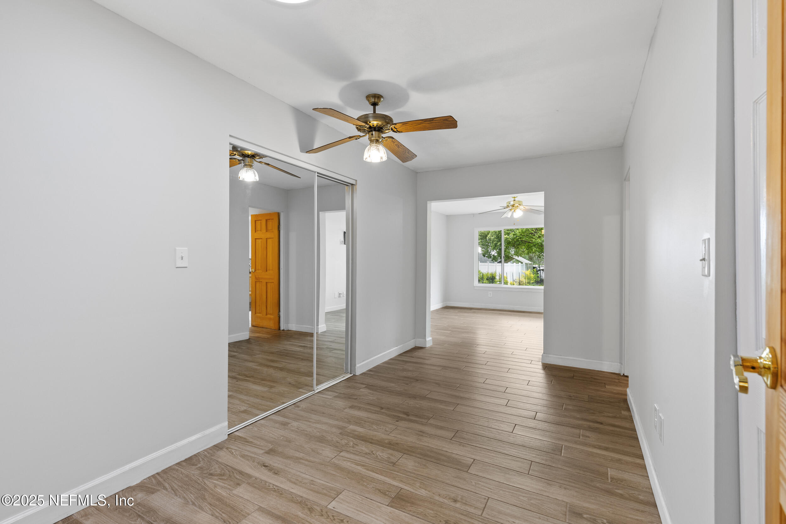 49 Nelsons Point Keystone Heights, FL 32656 - Photo 22 of 39 a view of an empty room with window and wooden floor