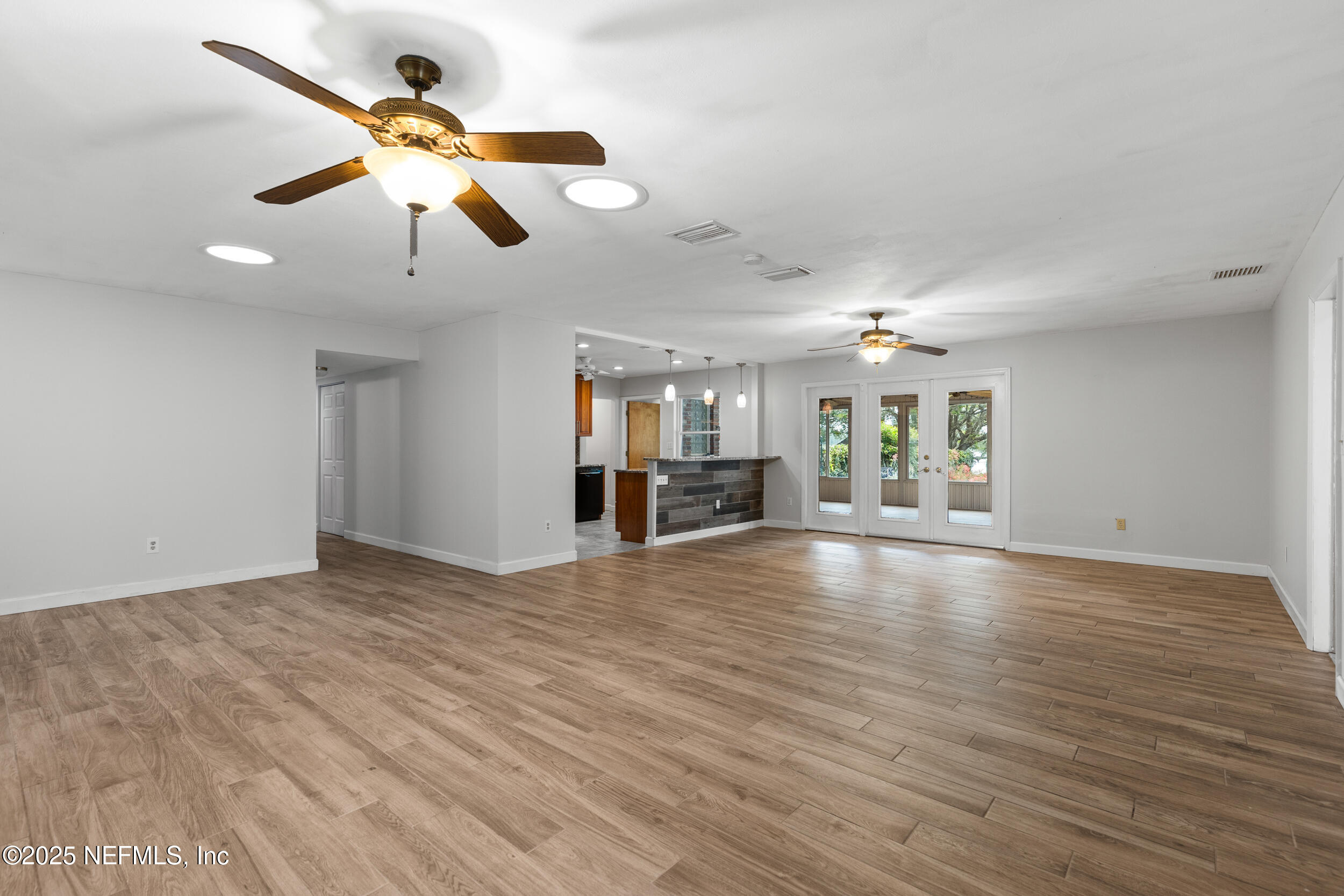 49 Nelsons Point Keystone Heights, FL 32656 - Photo 9 of 39 a view of an empty room with wooden floor and a window