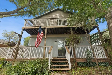 a view of a house with brick walls and wooden deck