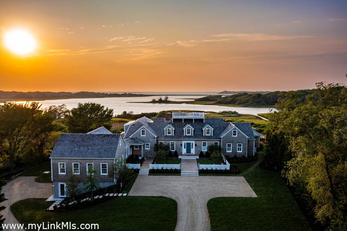 256 Polpis Road Nantucket, MA 02554 - Photo 1 of 30 a view of multiple houses with a city street