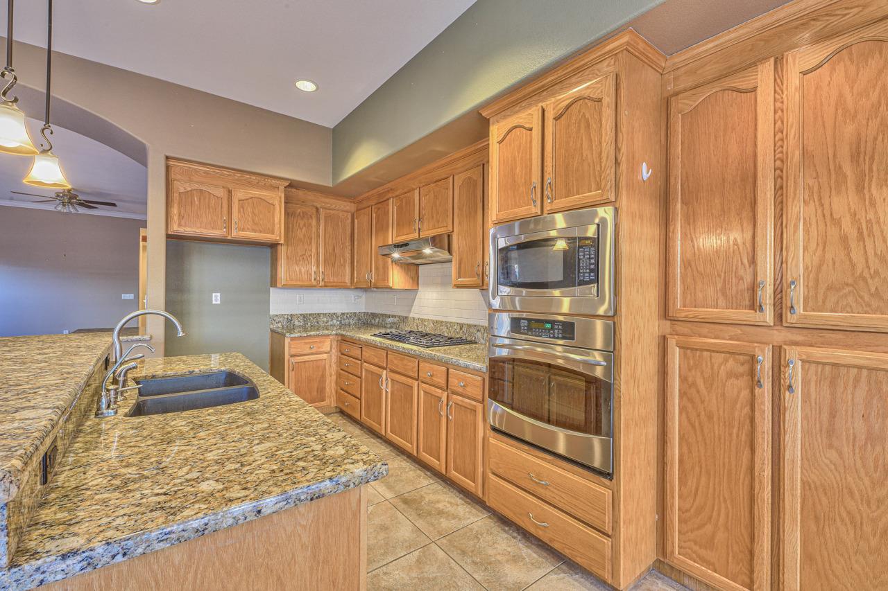 20 Glen Falls Circle Salinas, CA 93906 - Photo 11 of 37 a kitchen with stainless steel appliances granite countertop a refrigerator and stove