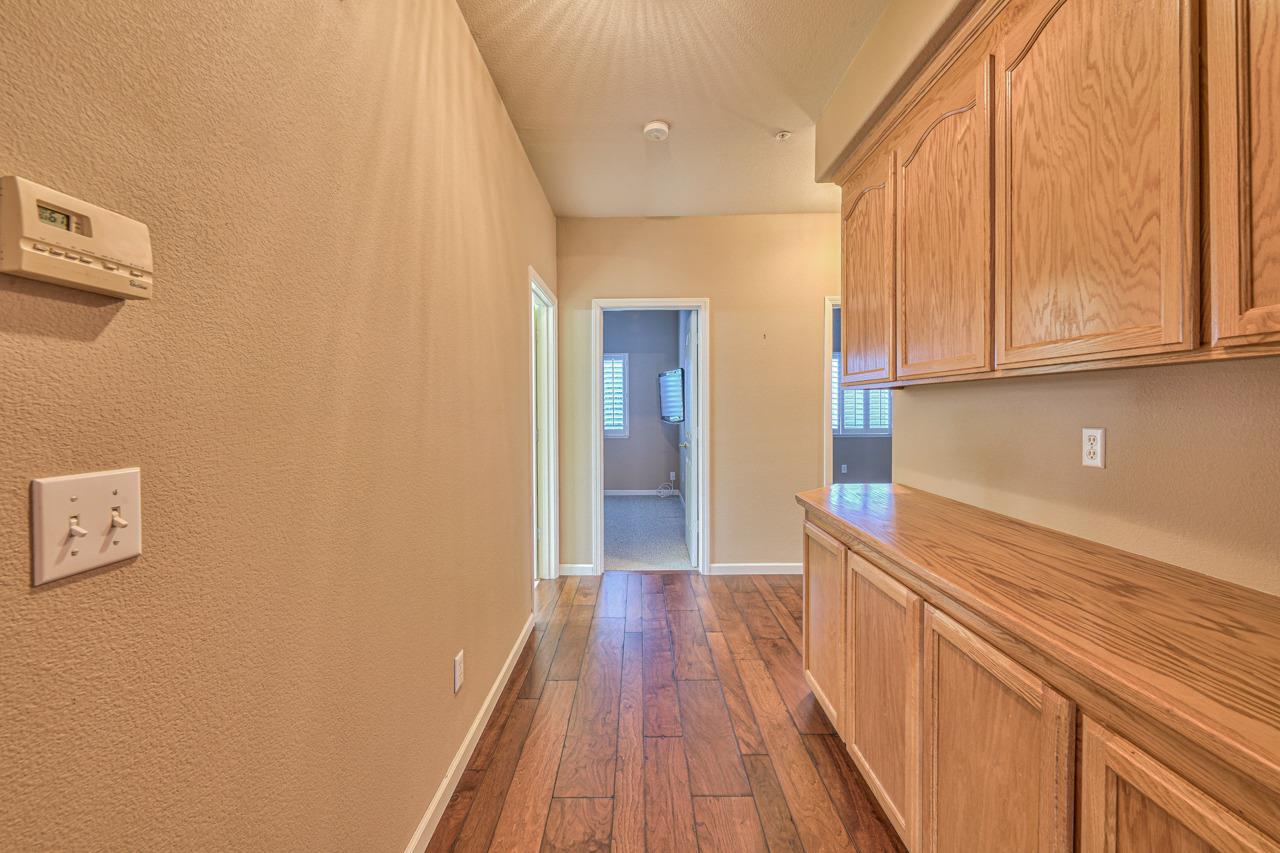 20 Glen Falls Circle Salinas, CA 93906 - Photo 19 of 37 a view of a hallway with wooden floor and cabinets