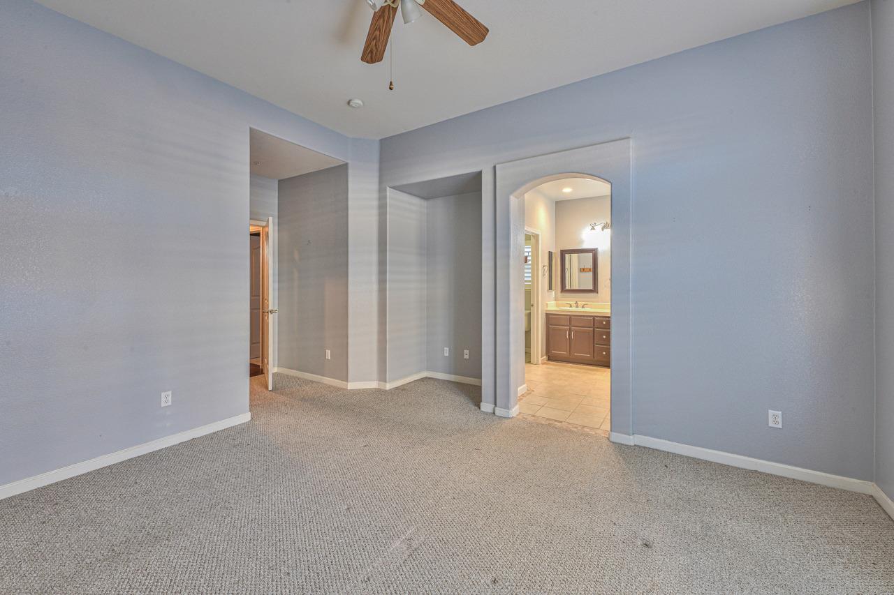 20 Glen Falls Circle Salinas, CA 93906 - Photo 23 of 37 an empty room with closet and a chandelier fan