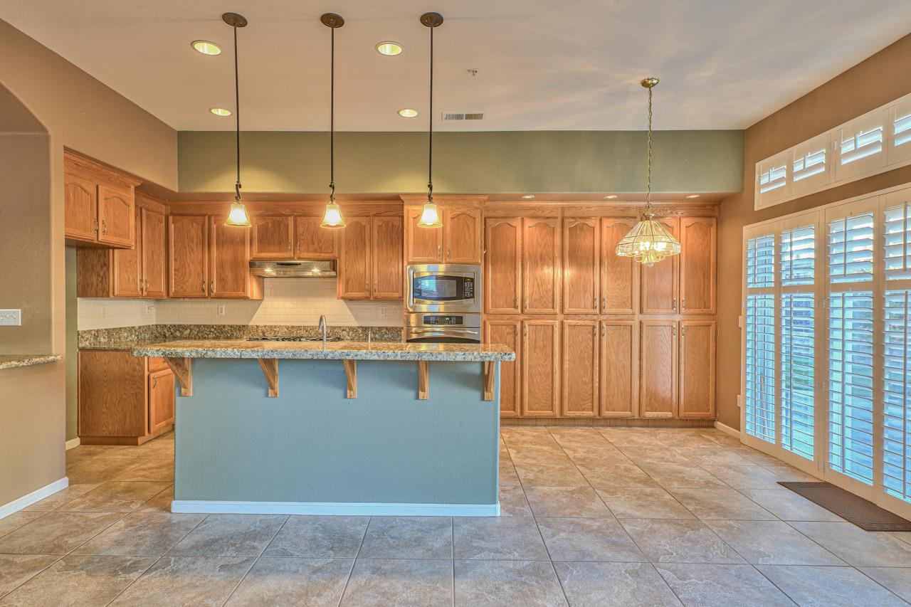 20 Glen Falls Circle Salinas, CA 93906 - Photo 10 of 37 a kitchen with kitchen island granite countertop a sink window and cabinets