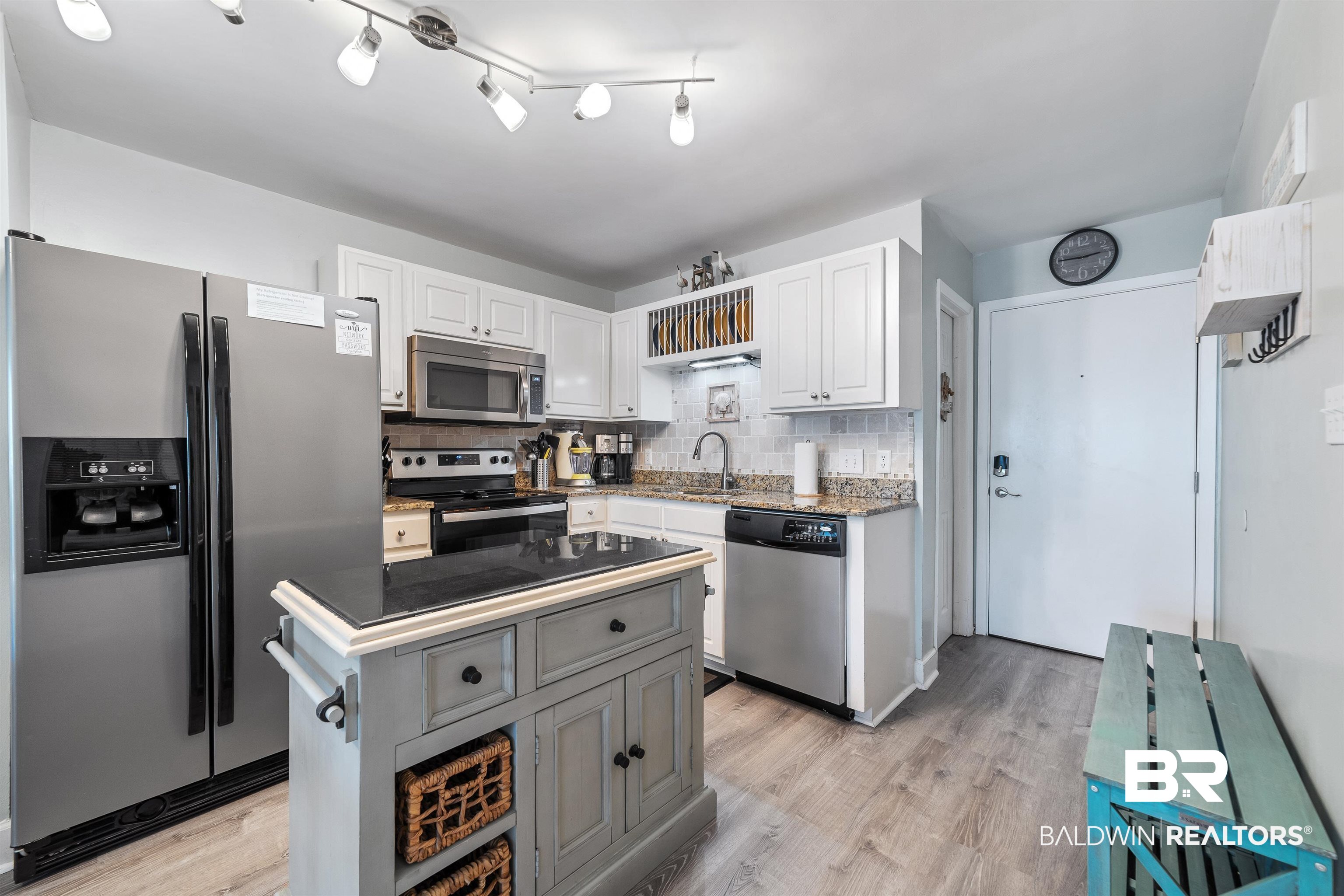 400 Plantation Road, Unit 2123 Gulf Shores, AL 36542 - Photo 4 of 44 Kitchen featuring white cabinetry, stainless steel appliances, rail lighting, decorative backsplash, and light hardwood / wood-style floors
