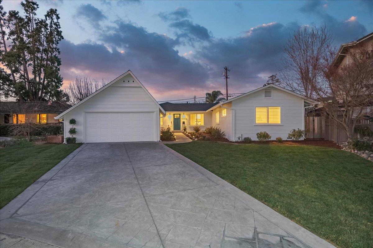 a view of a house with a big yard and large tree