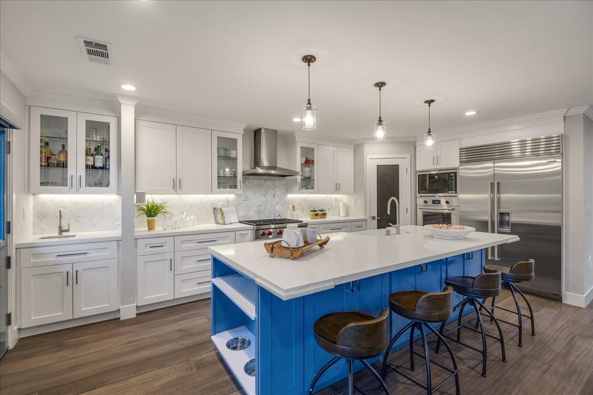 1450 Padres Drive San Jose, CA 95125 - Photo 18 of 52 a kitchen with stainless steel appliances granite countertop a stove a sink dishwasher a refrigerator and white cabinets with wooden floor