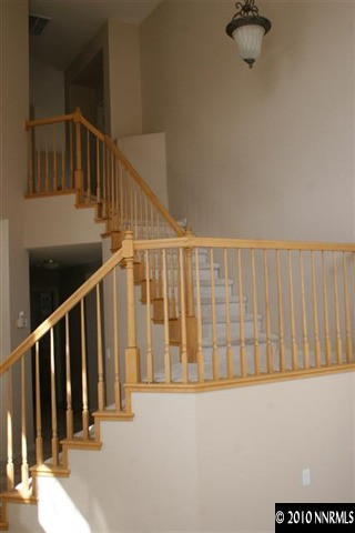 9590 Apache Rose Drive Reno, NV 89521 - Photo 2 of 9 a view of staircase with railing and white walls