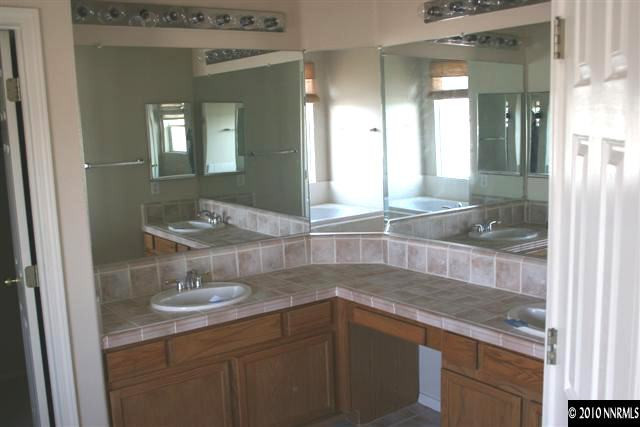 9590 Apache Rose Drive Reno, NV 89521 - Photo 6 of 9 a bathroom with a sink and a mirror
