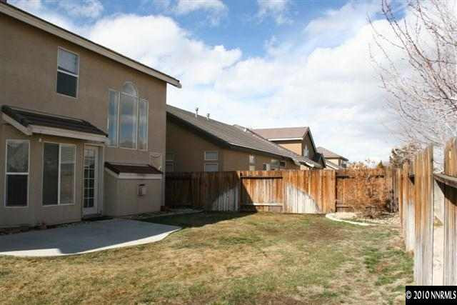 9590 Apache Rose Drive Reno, NV 89521 - Photo 8 of 9 a view of a house with a backyard