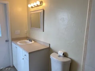 a bathroom with a sink toilet and mirror