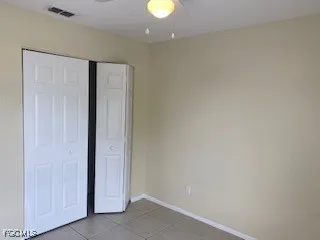 a view of an empty room with a window and closet