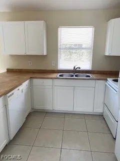 a kitchen with a sink window and cabinets