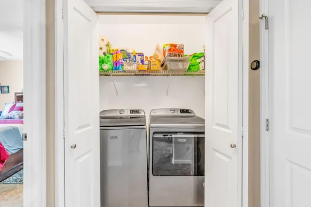 a view of storage and utility room with washer and dryer