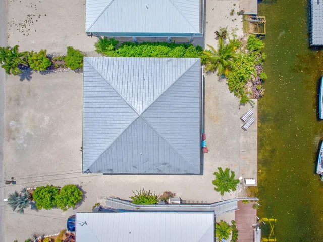 an aerial view of a house with a yard and potted plants