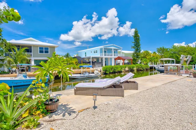 a view of a house with sitting area and garden