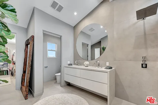 a bathroom with a shower and a sink