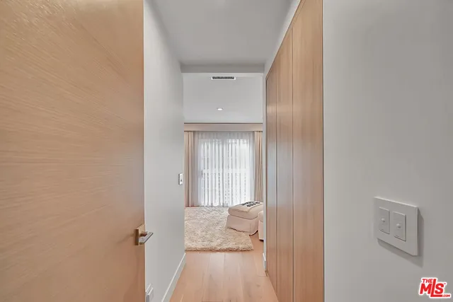 a bedroom with a bed a couch and a window