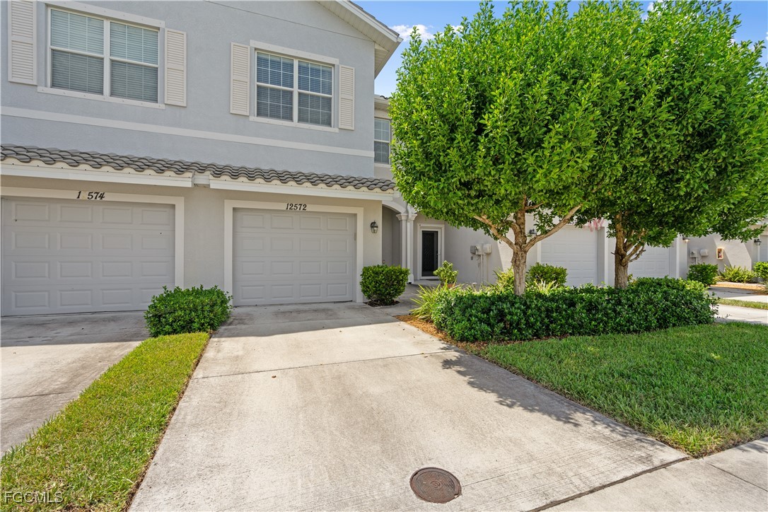 a front view of a house with a yard and garage