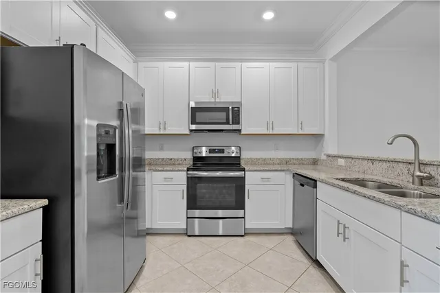 a kitchen with cabinets and stainless steel appliances