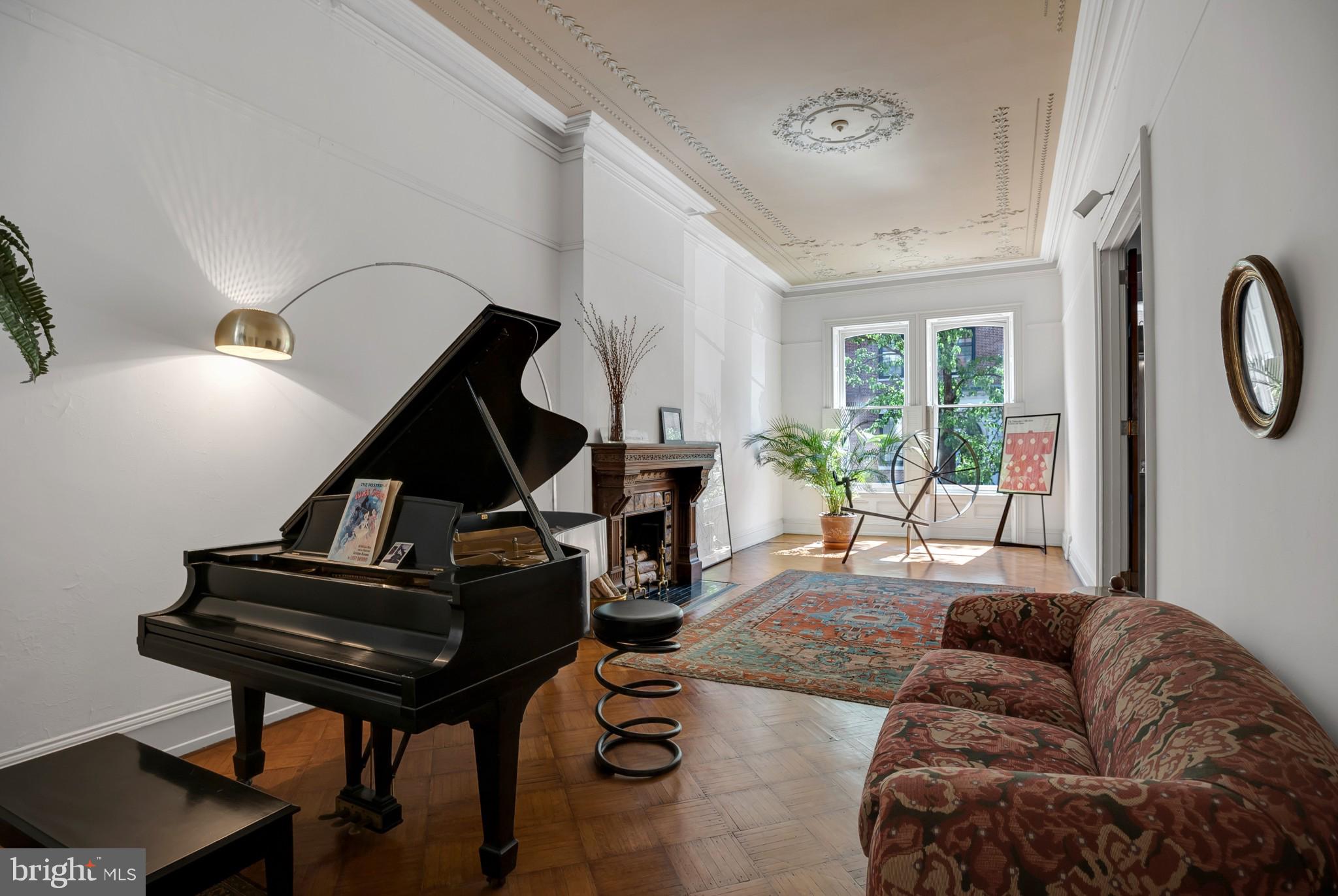a living room with furniture and a piano