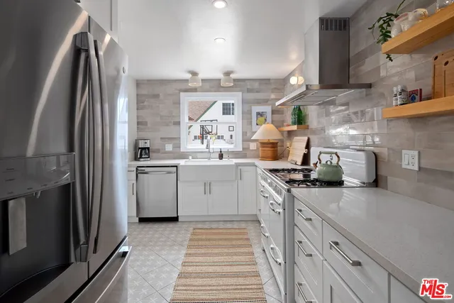 a kitchen with a sink cabinets and stainless steel appliances