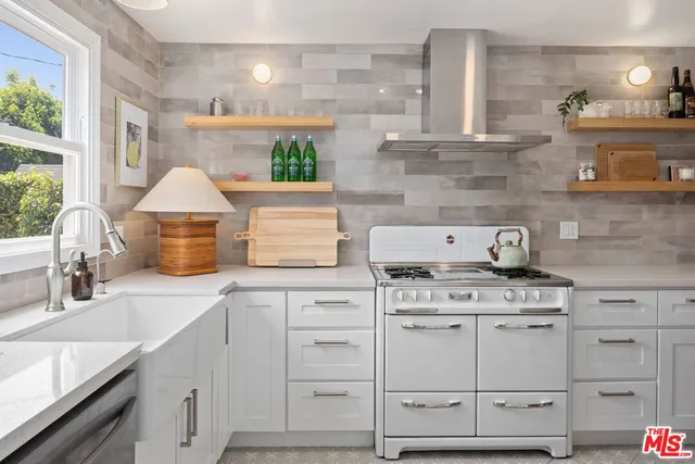 a kitchen with cabinets appliances and a counter space