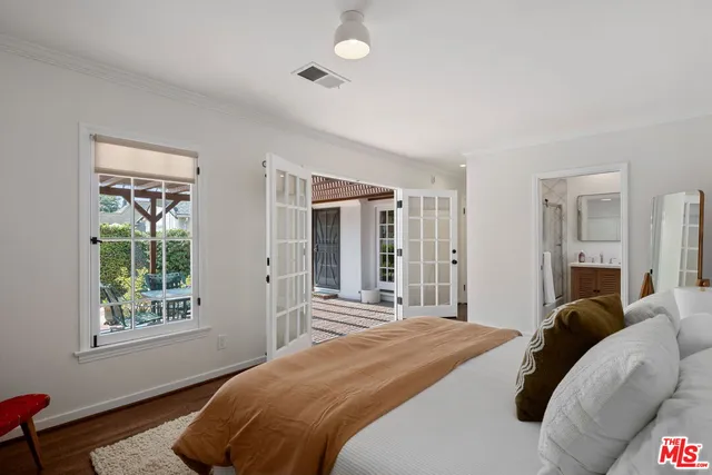 a bedroom with a bed and glass windows