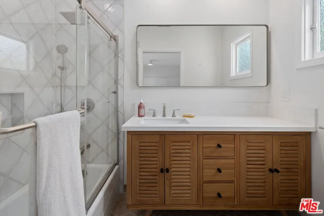 a bathroom with a sink and a mirror