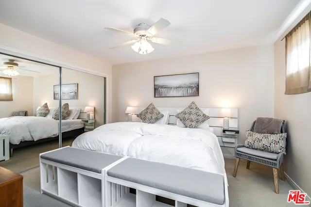 a bedroom with two beds and a couch