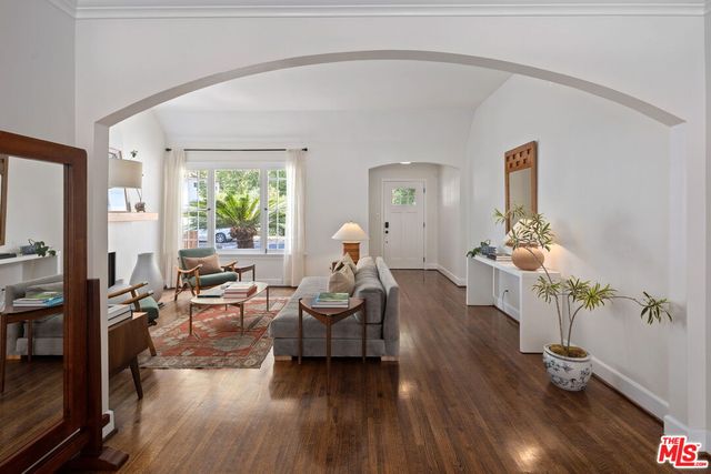 a living room with furniture and wooden floor