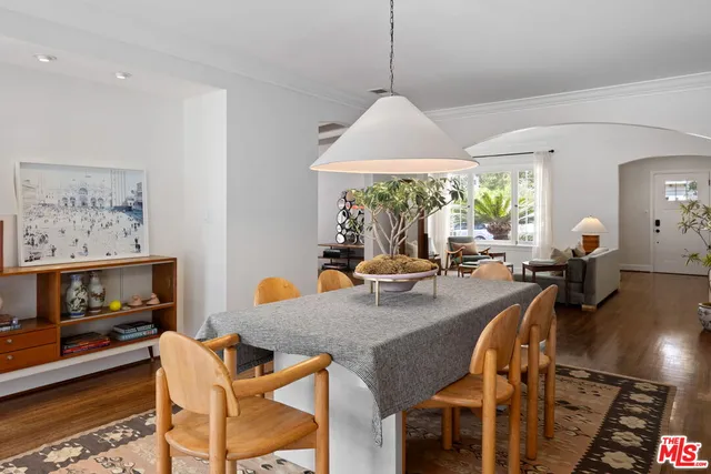 a dining room with furniture a window and a chandelier