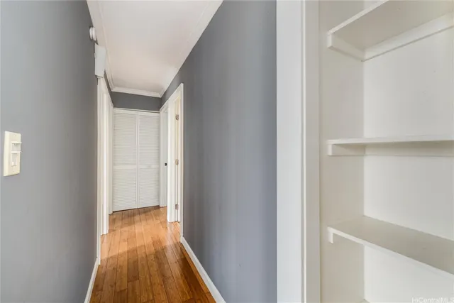 a view of a hallway with wooden floor