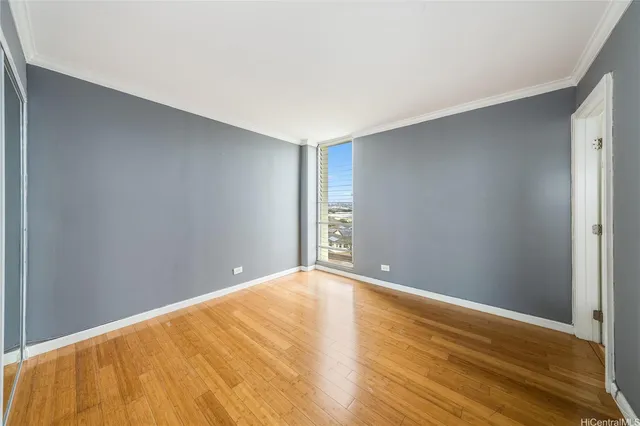 a view of empty room with wooden floor