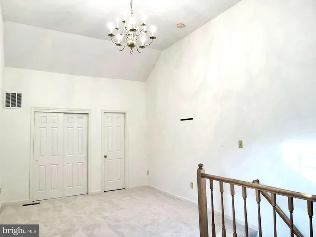 a view of a chandelier fan and entryway