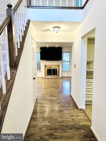 a view of a living room with wooden floor and staircase