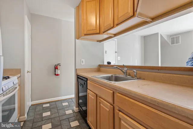 a kitchen with a stove a refrigerator and a sink