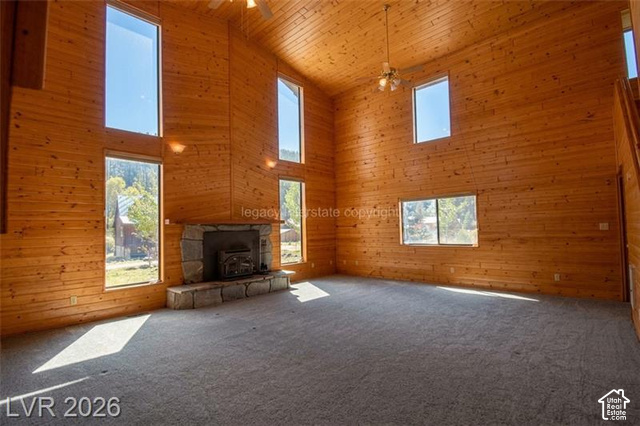 1129 Ponderosa Road, Unit 40 Hatch, UT 84735 - Photo 2 of 47 Expansive room with high vaulted wood-paneled ceilings, a stone-clad fireplace with a hearth, and multiple windows