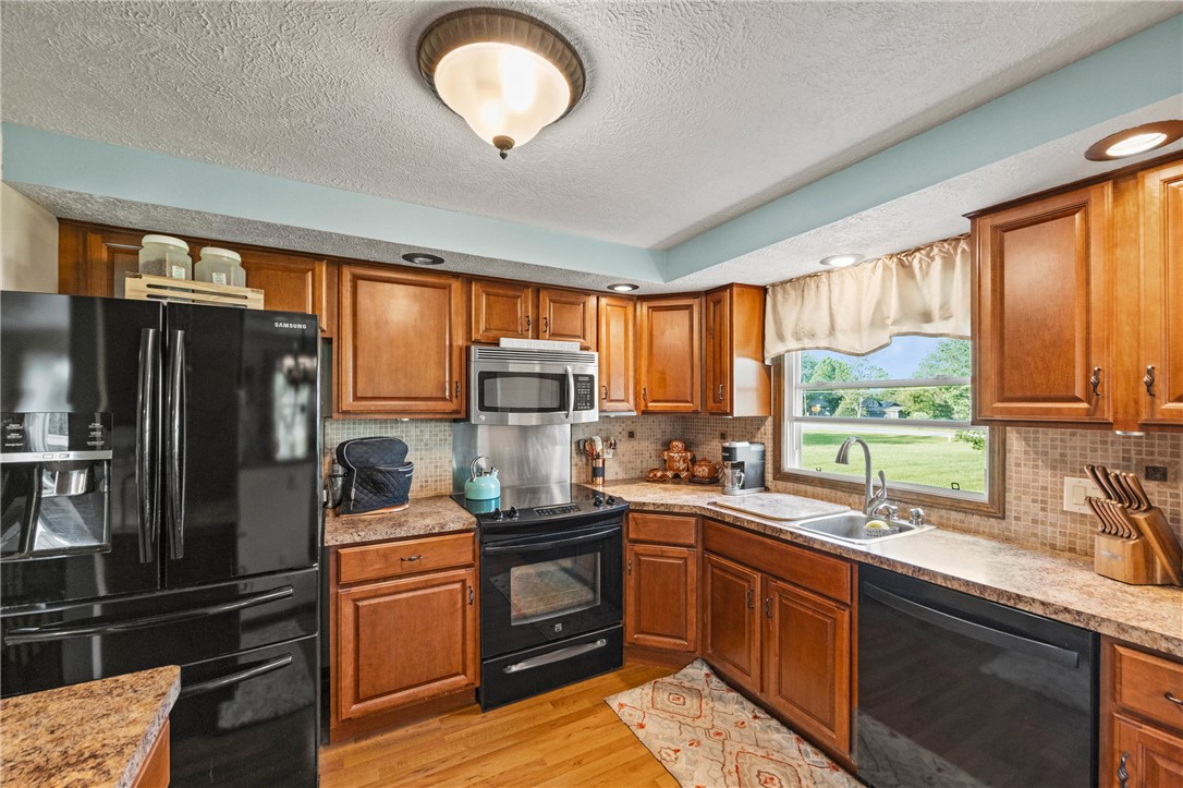 1140 Willits Road Ontario, NY 14519 - Photo 5 of 50 Kitchen in main part of house- newer matching appliances, wine rack, custom sink covers.