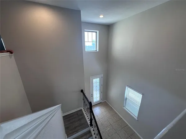 a view of an empty room and wooden floor