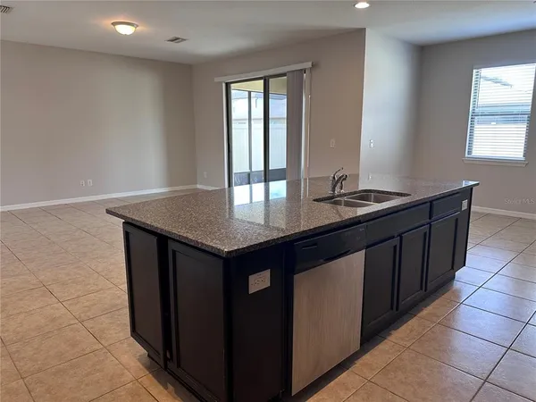 a kitchen with granite countertop a sink and a counter top space
