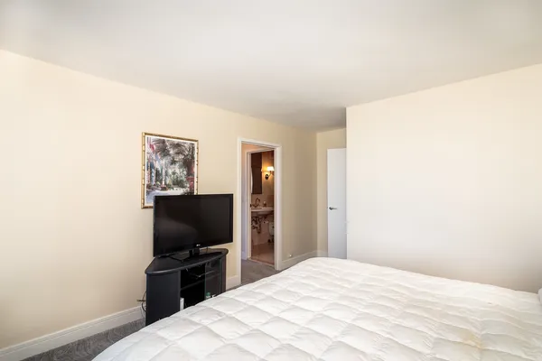 a bedroom with a bed and a flat screen tv