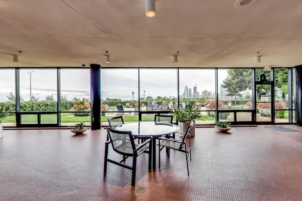 a view of a work space with furniture and floor to ceiling windows