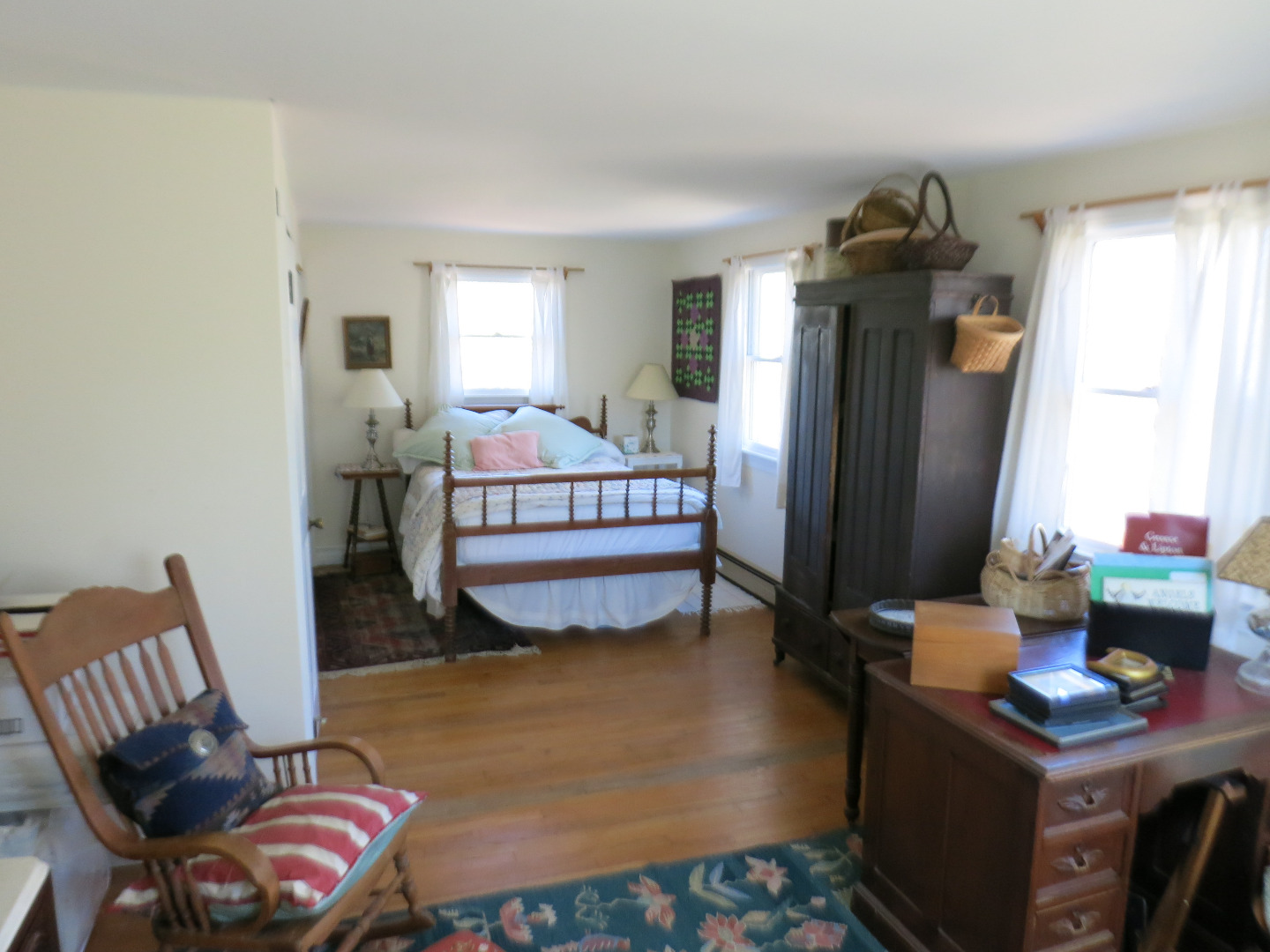 86 Marthas Road Edgartown, MA 02539 - Photo 18 of 25 a bedroom with a bed and wooden floor