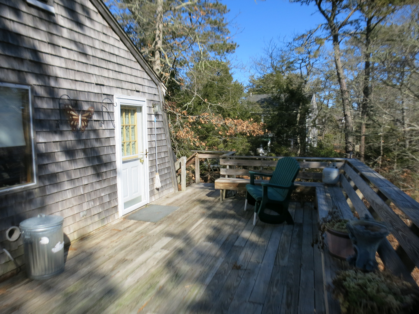 86 Marthas Road Edgartown, MA 02539 - Photo 5 of 25 a view of a patio with table and chairs with wooden floor and fence