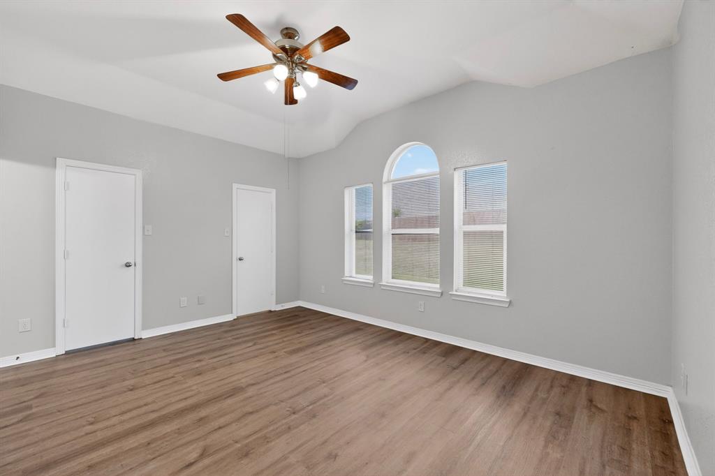 3401 Newgate Street Midlothian, TX 76065 - Photo 19 of 34 Spacious room featuring wood-finish flooring, vaulted ceiling, and an arched window