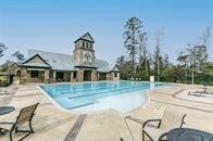 515 Mill Creek Road Pinehurst, TX 77362 - Photo 44 of 48 Inviting community pool area with ample deck space and seating. The pool is adjacent to the clubhouse. Perfect for relaxation and social gatherings.
