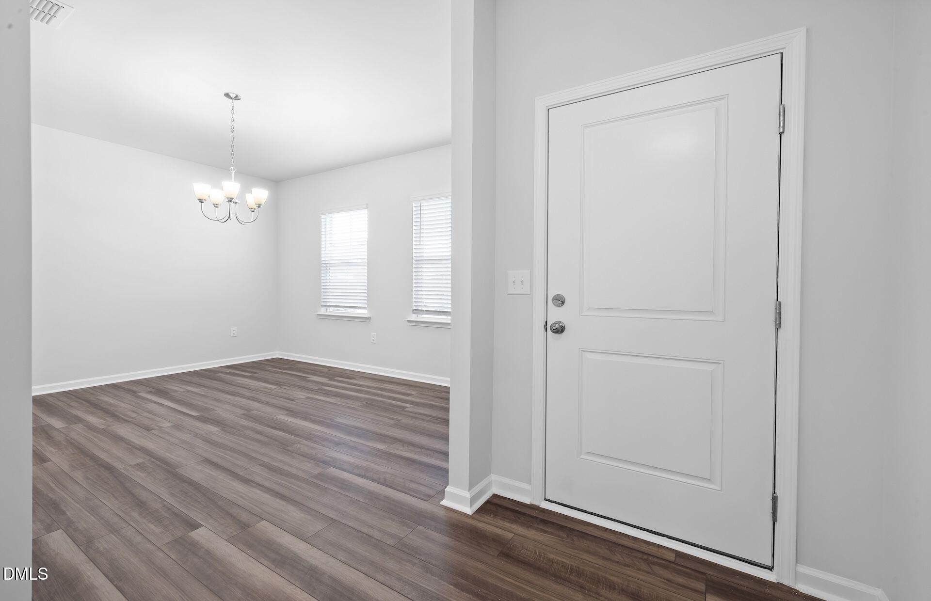 664 Ben Ledi Court Raleigh, NC 27603 - Photo 9 of 32 wooden floor in an empty room with a window