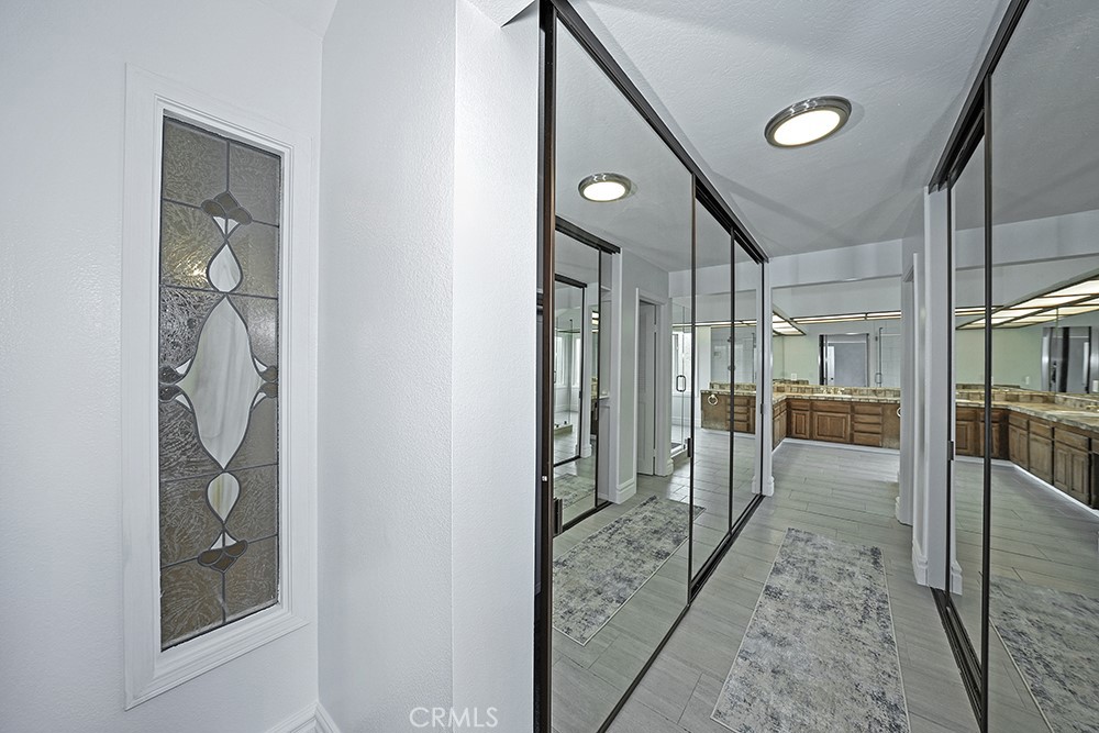 28312 Driza Mission Viejo, CA 92692 - Photo 15 of 21 a view of a hallway with wooden floor and a living room